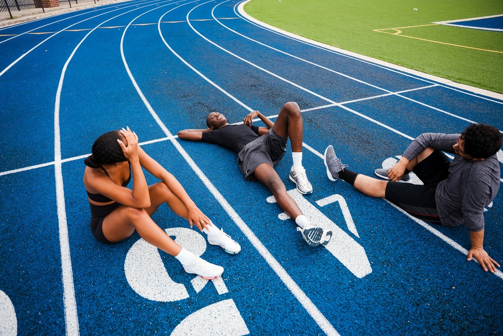 People resting on a running track
