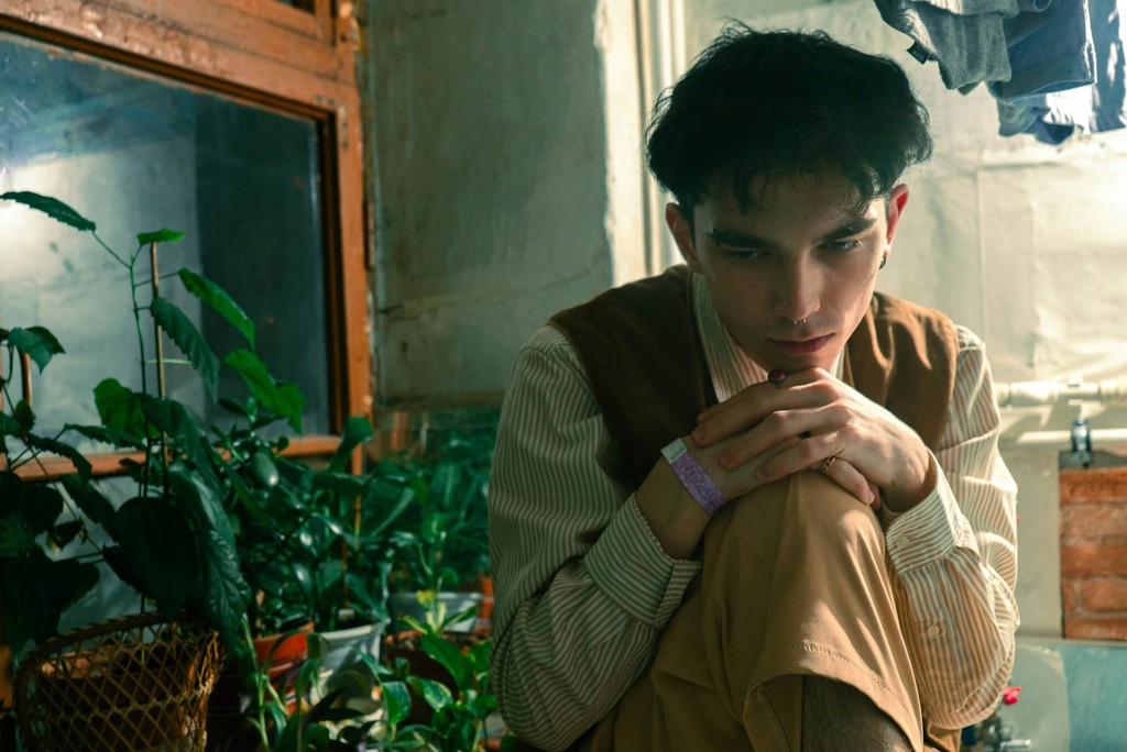 A man thinking among plants
